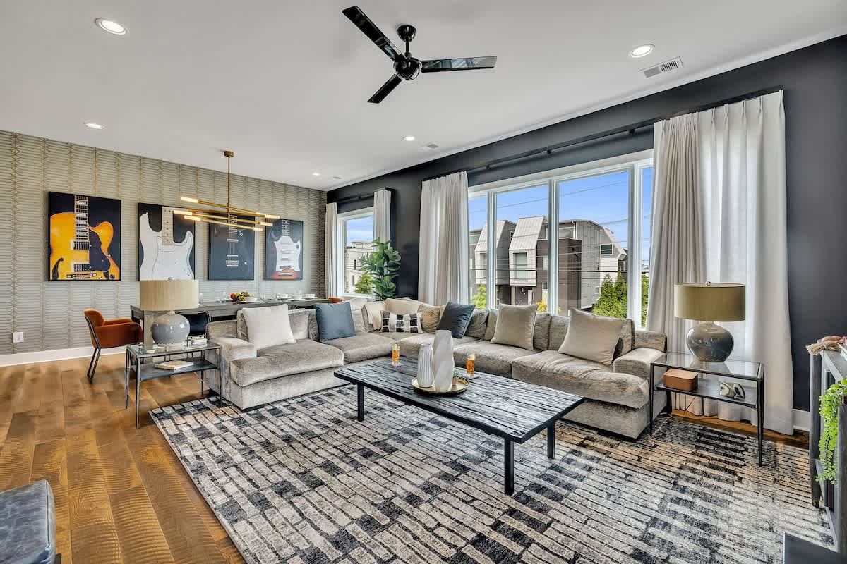 Open concept living area with designer furnishings and smart TV.