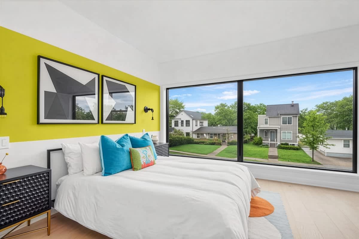 Vibrant and cheerful second bedroom with a queen bed, bold accent wall, large picture window, and its own en suite bathroom. (2nd Floor)
