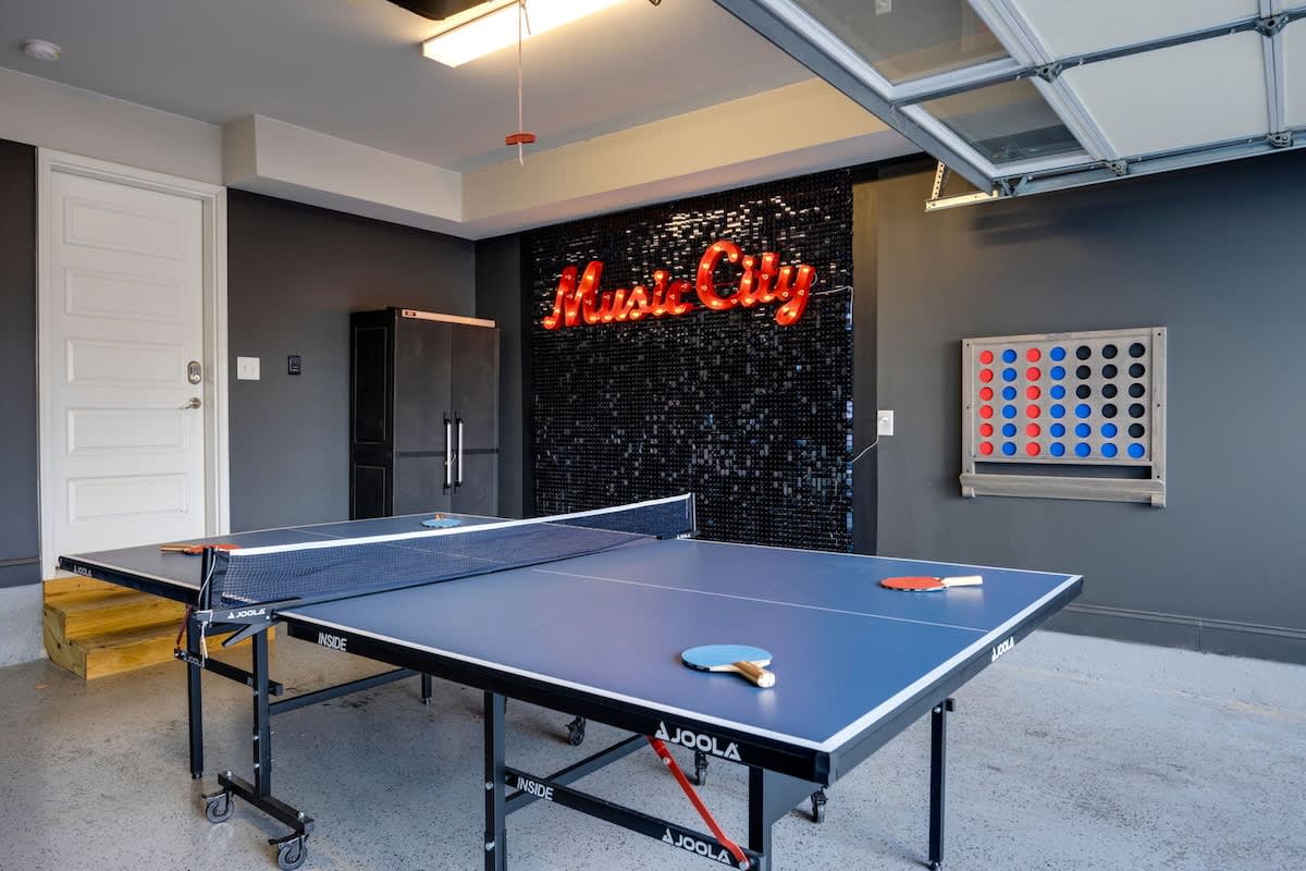 1st Floor: Garage converted Game Room with a ping pong table, giant connect four, and photo wall.