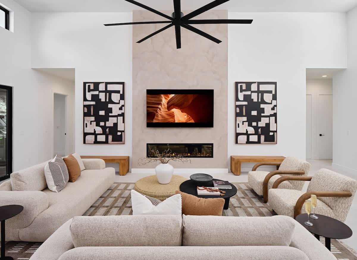 Unit 2: Grand open-concept living space with designer decor, featuring a fireplace and Smart TV.