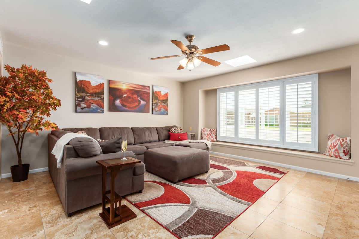 Bright open-floor concept living room featuring comfortable sectional and smart TV.