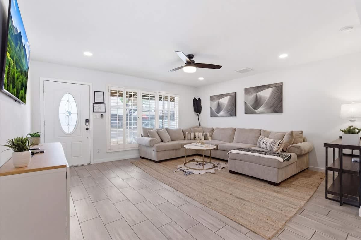 Bright and open living area featuring cozy furnishings and a Smart TV.