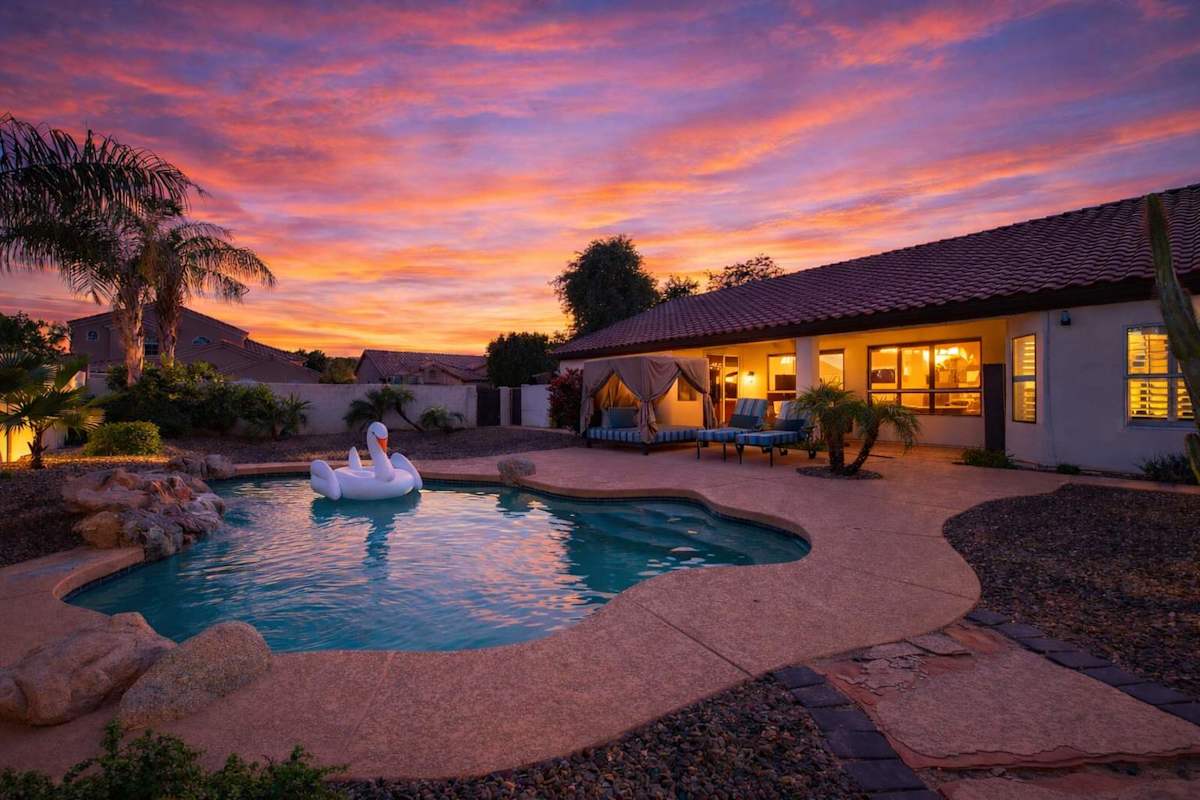 Backyard featuring pool, hot tub, bbq grill, outdoor cabana bed, sun loungers, and outside dining area.