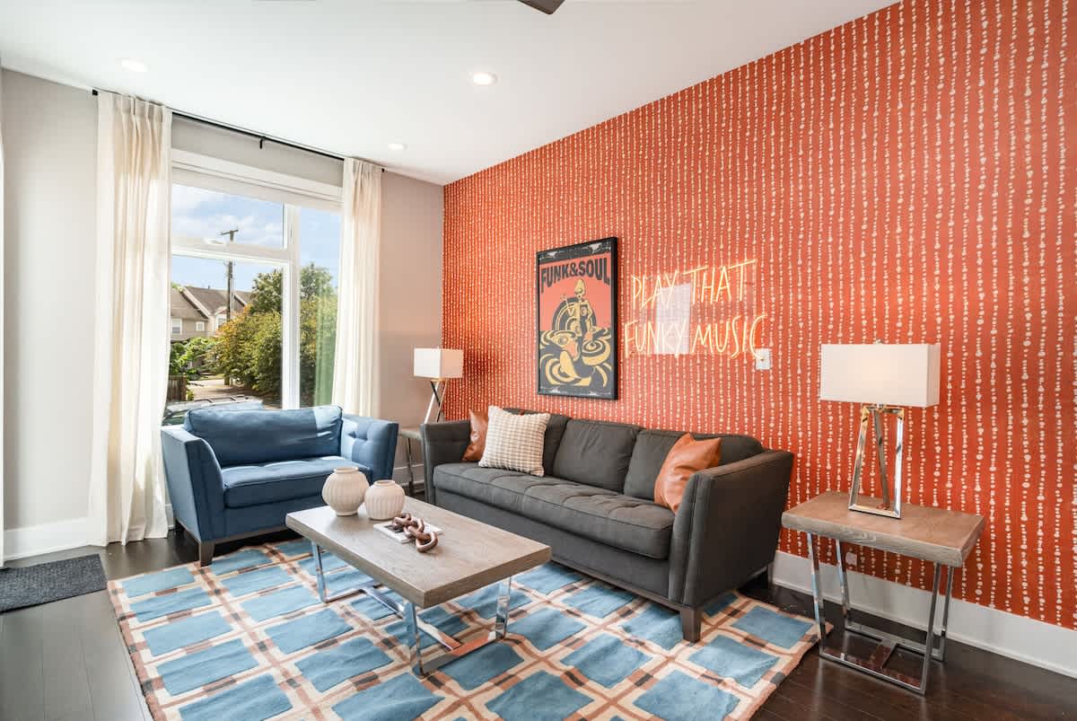 2nd Floor: Open-concept living area featuring a Smart TV, cozy furnishings, and a private patio.