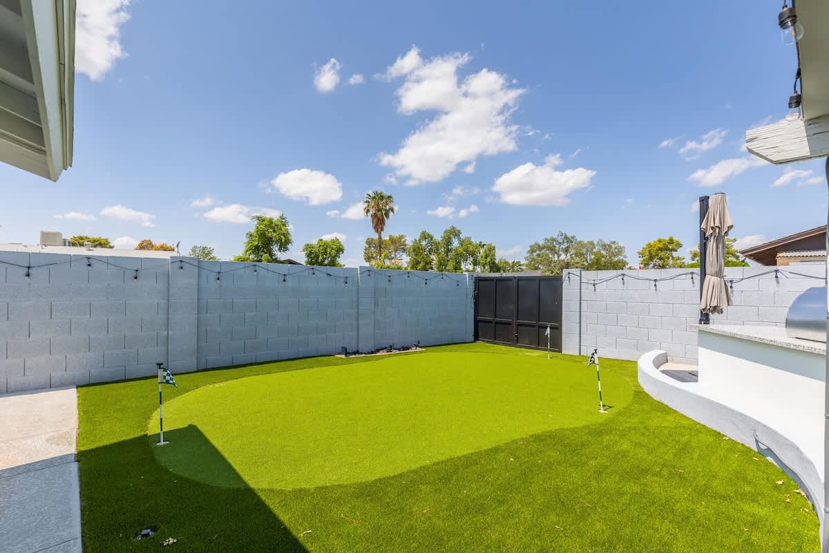 Private backyard with pool, built in grill, putting green and lounge areas