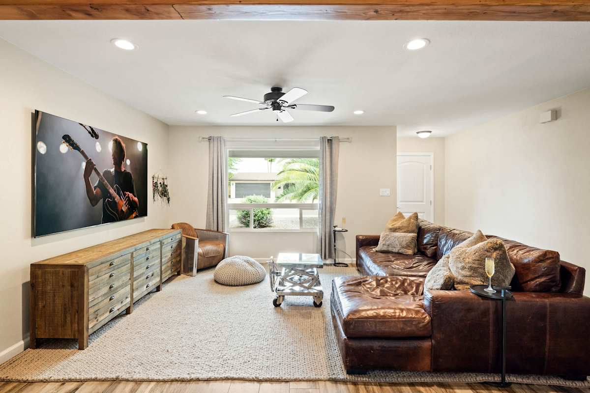 Bright and open living area featuring cozy furnishings and a smart TV.