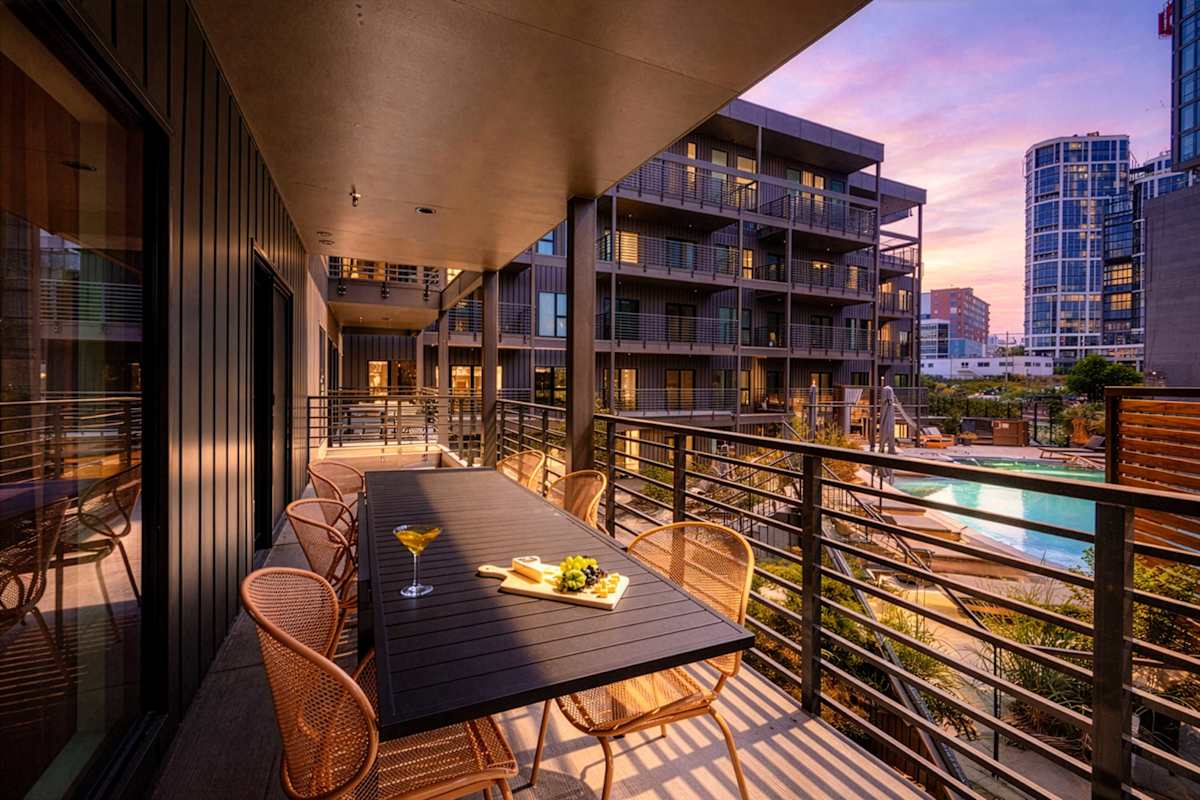 Step out onto your private balcony and enjoy a view that overlooks the expansive swimming pool area. It's the perfect spot to soak in the sights and sounds of this aquatic oasis while basking in the c