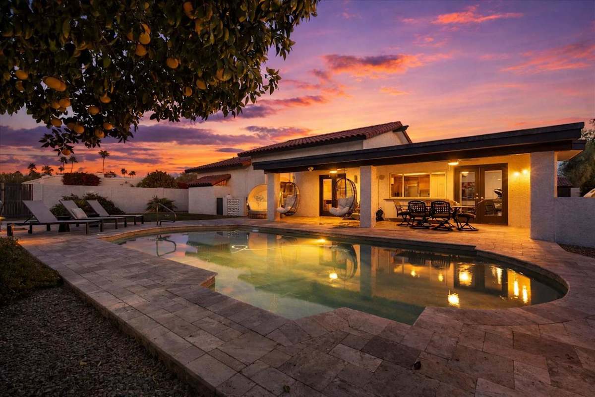 Sparkling heated optional pool, putting green, fire pit, lounge areas, dining table, BBQ grill, sun loungers, swing chairs, and bocce ball.