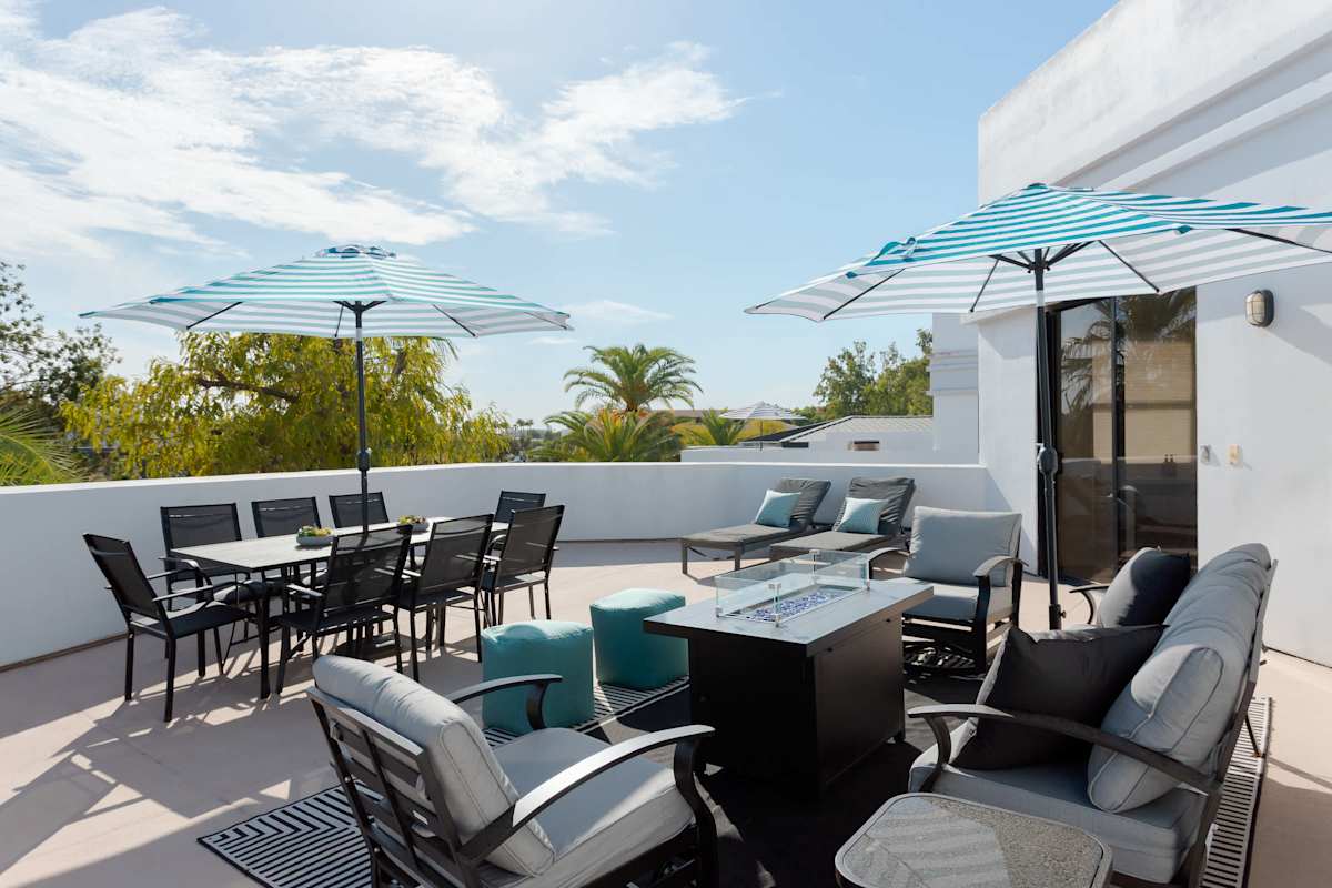 Private balcony with lounge seating with built in fire pit table, a BBQ grill, outdoor dining area for 8, sun loungers, and plenty of room to relax outdoors in the Scottsdale sunshine.