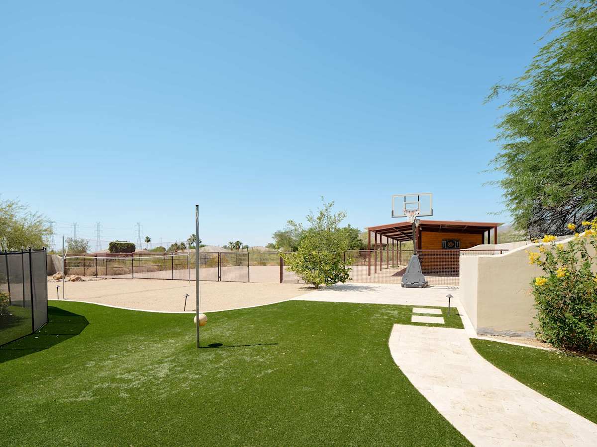 Private backyard with a sparkling pool and hot tub, BBQ grill, plus fun amenities including tetherball, volleyball, basketball, a horse stable with swings, mini golf, and darts.