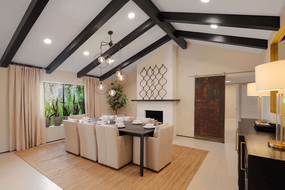 Elegant formal dining room with seating for eight, soaring vaulted ceilings, and statement lighting, creating a refined setting for memorable dinners.