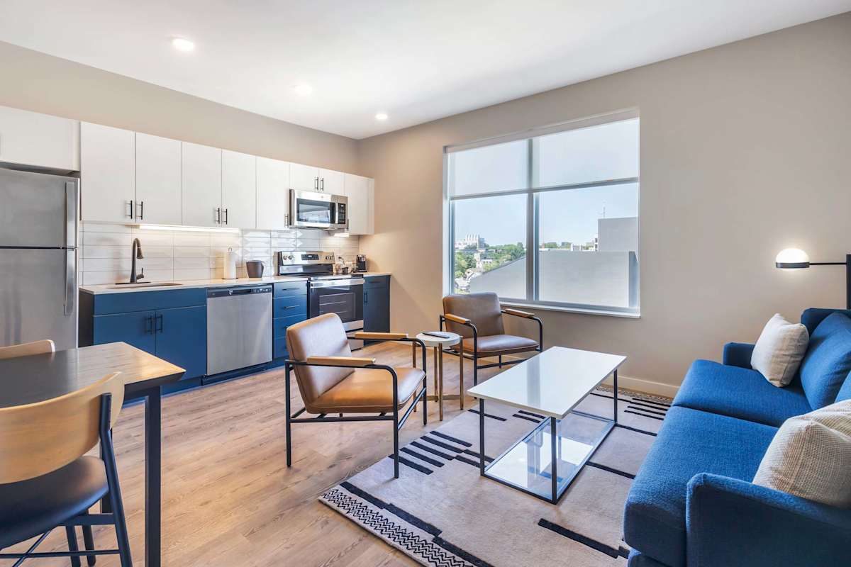 Living Area with plush seating, a Smart TV, and an open-concept layout that seamlessly connects to the kitchen.