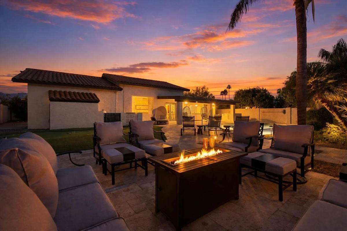 Sparkling heated optional pool, putting green, fire pit, lounge areas, dining table, BBQ grill, sun loungers, swing chairs, and bocce ball.