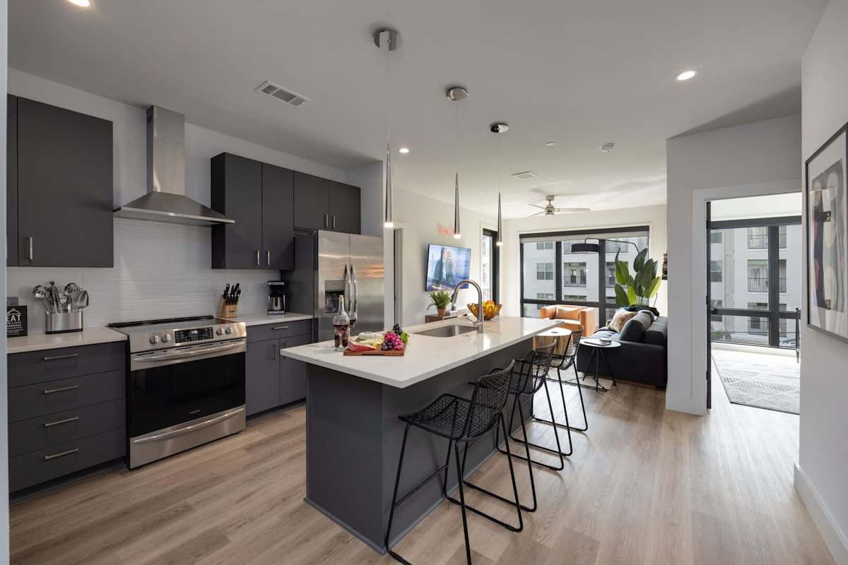 Fully equipped kitchen stocked with your basic cooking essentials. Includes stainless steel appliances, small kitchen island, coffee machine, and toaster.