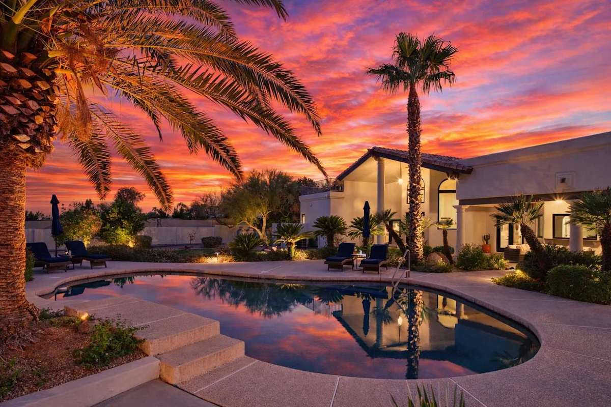 Resort style backyard with private pool, hot tub, lounge chairs, outdoor dining, corn hole, built in grill and fire pit!