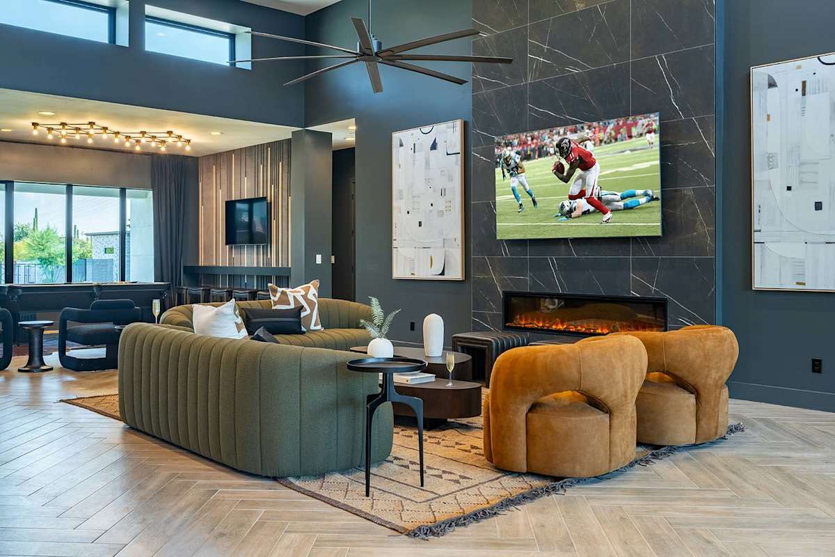 Unwind in this spacious living area with designer furnishings, a large Smart TV, an electric fireplace, and an open layout perfect for relaxation or game day.