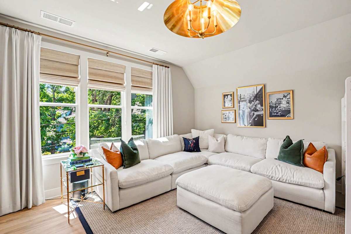 Bright and open living area featuring a smart TV, cozy furnishings, and 2 Twin-over-Twin bunk beds.
