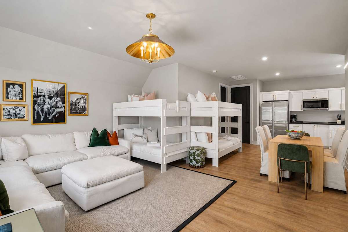 Bright and open living area featuring a smart TV, cozy furnishings, and 2 Twin-over-Twin bunk beds.