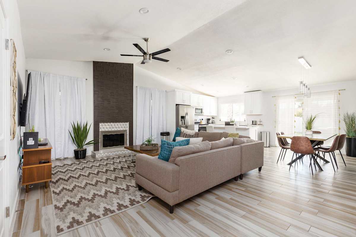 Open living area with a smart TV, cozy furnishings, and a fireplace.