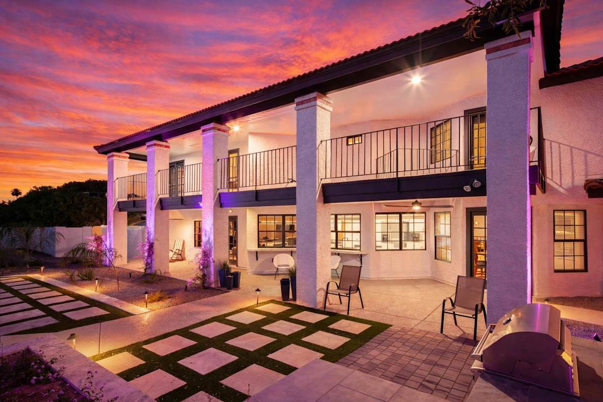 Resort-style backyard with sparkling heated pool & spa, sun loungers, BBQ grill, covered gazebo with multiple lounge areas, outdoor seating, and putting green setup.