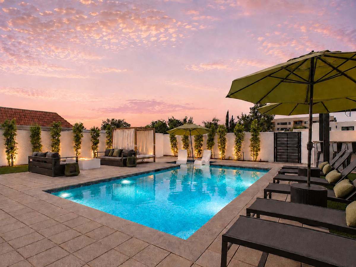 Incredible new $400K backyard just completed with a view of the Scottsdale Civic Center, a pool, fire pit, sun loungers, cabana, and BBQ grill with bar seating!