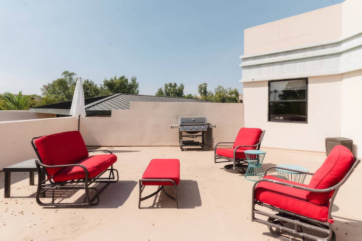 Unit 1: Expansive private balcony featuring lounge seating, a BBQ grill, and plenty of space to soak up the Scottsdale sunshine or unwind in the fresh desert air.