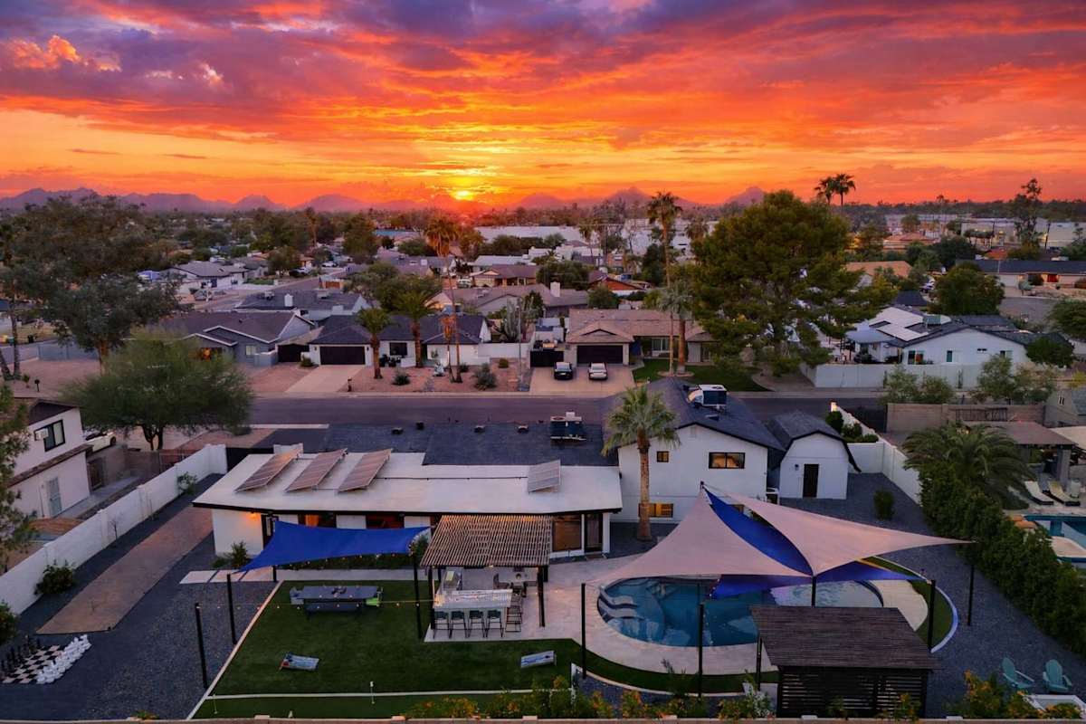 A stunning twilight view of Sunburst Estate, your private oasis beneath the desert sky.