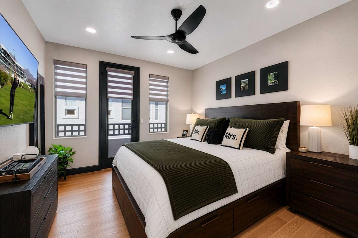 Unwind in the stylish primary suite, complete with a king bed, smart TV, private balcony, a walk-in closet, and a private en-suite bathroom for a comfortable, relaxing retreat.