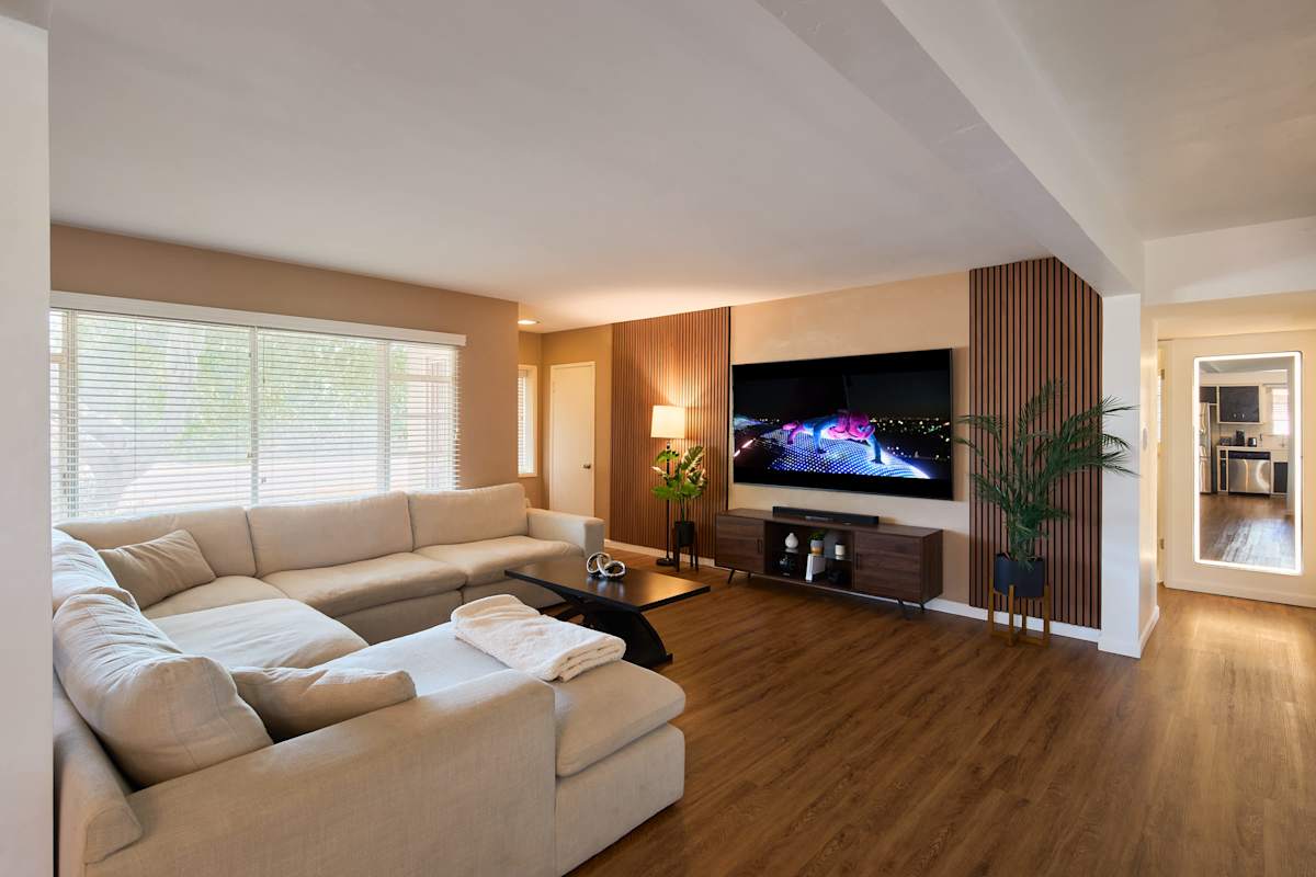 Stretch out on the plush sectional in the primary living area after a day of exploring, with wood slat accents and warm lamplight turning this corner into the spot you'll linger in longest.