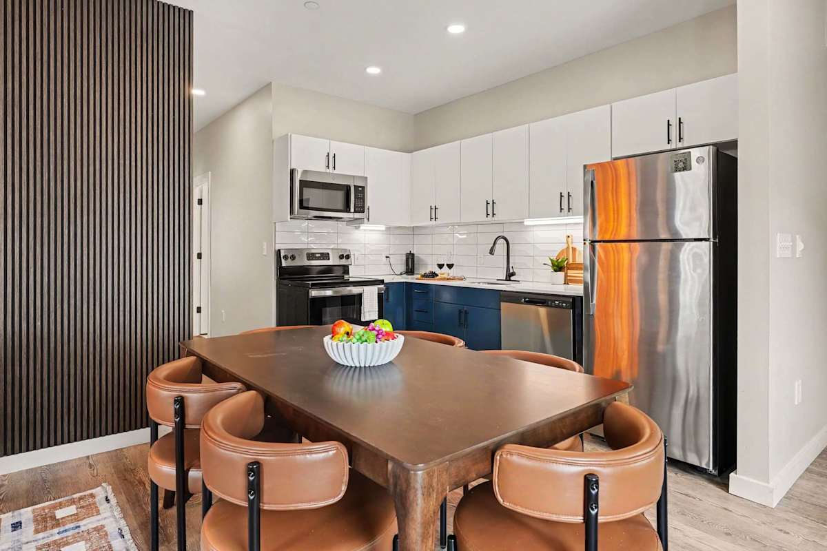 This modern kitchen features sleek stainless steel appliances, dining area for 6, and all the essentials you need for a comfortable and convenient stay. Open concept to living area. 