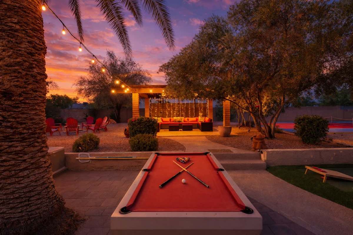 Sparkling pool, hot tub, sun loungers, gazebo, firepit, BBQ, cornhole, and ample seating.