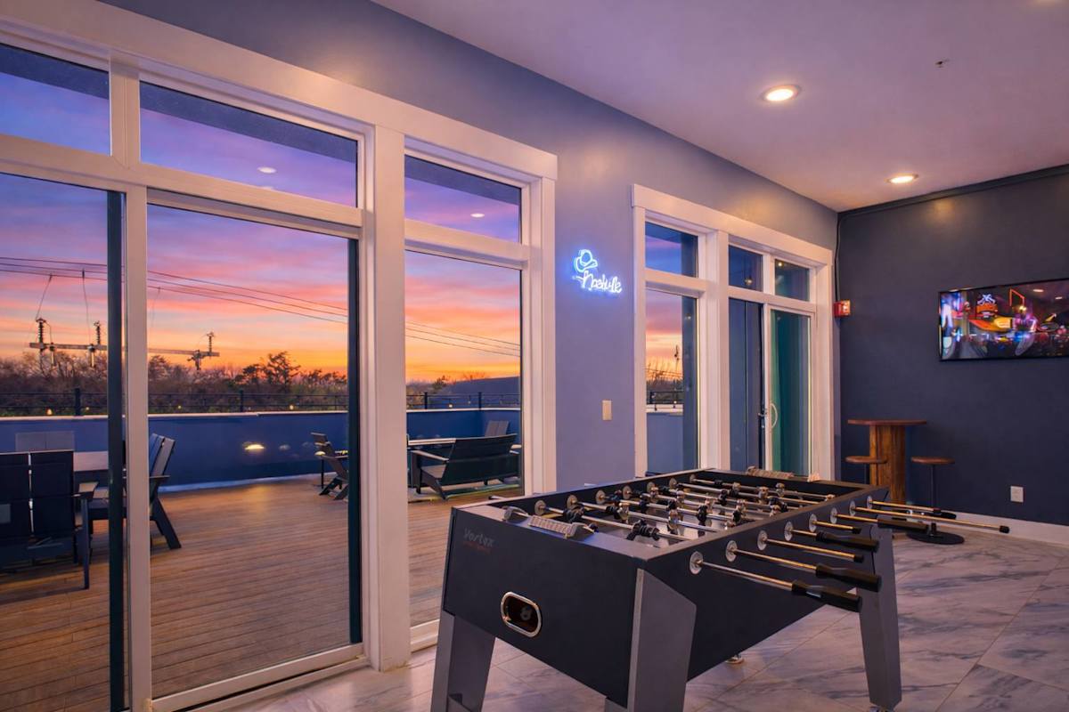 Communal Area: Shared game room with a foosball table, dart board, giant Connect 4, and Hok 21.