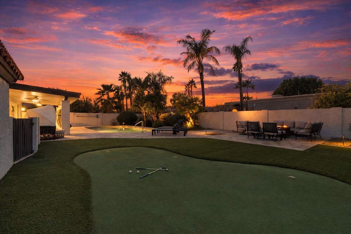 Sparkling heated optional pool, putting green, fire pit, lounge areas, dining table, BBQ grill, sun loungers, swing chairs, and bocce ball.
