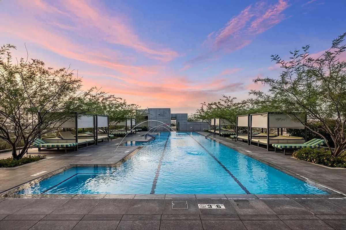 Communal Area: Rooftop area with a sparkling pool, hot tub, cabanas, sun loungers, outdoor kitchen with bar seating, BBQ grills, and outdoor dining areas.