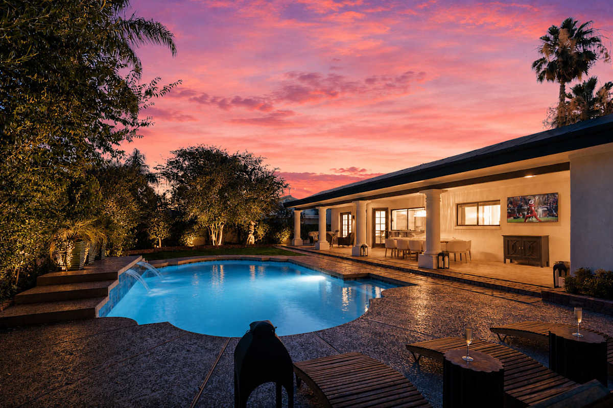 Private backyard oasis featuring a sparkling pool, BBQ grill, covered outdoor lounge, alfresco dining area, and poolside loungers, creating the perfect setting for sunny afternoons or evening gatherin
