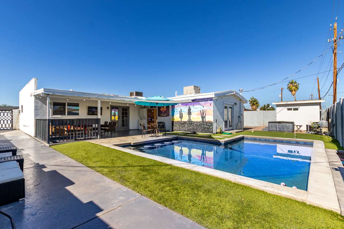 The sparkling pool offers plenty of room to swim or float, surrounded by lounge chairs and umbrella-shaded seating for relaxing between swims.