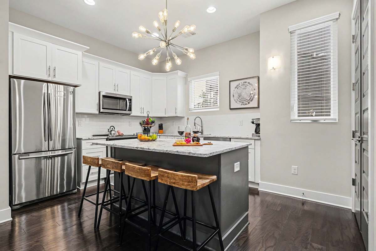 The fully equipped, modern kitchen is stocked with all the culinary essentials, including stainless-steel appliances and a wine cooler. (2nd Floor)