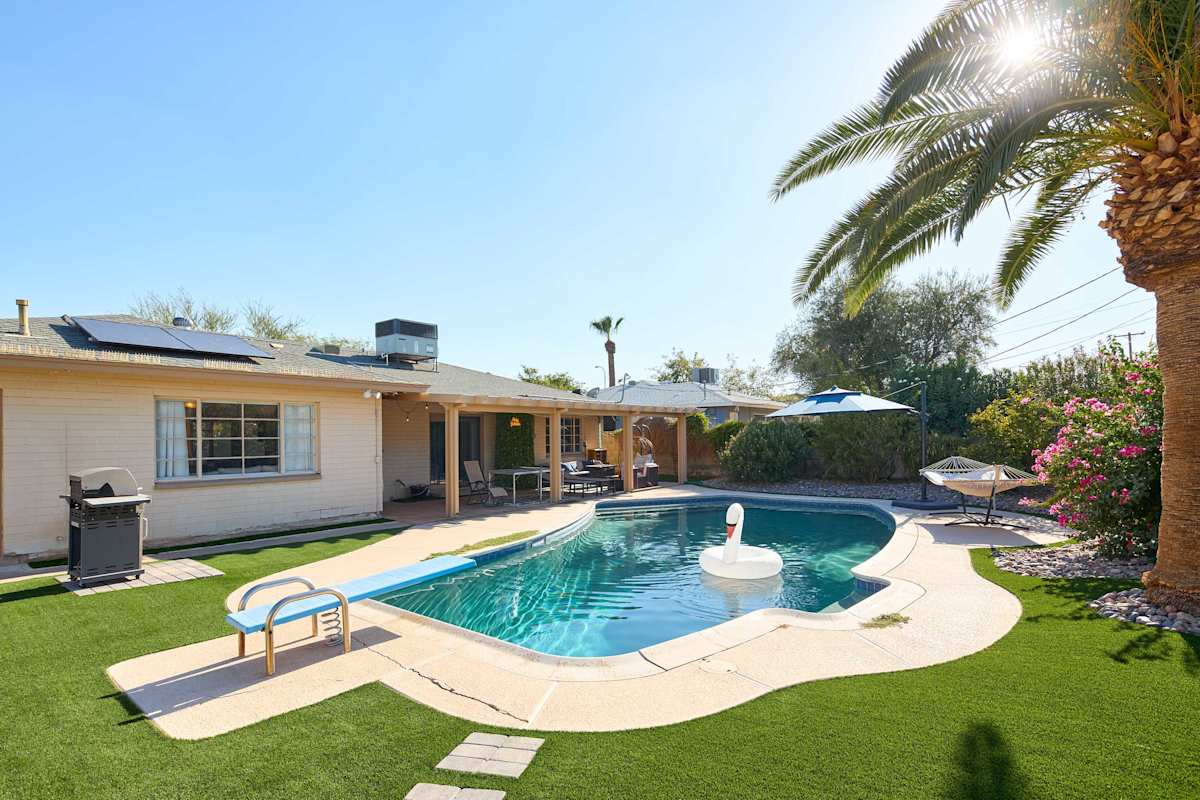 Take the plunge off the diving board into the sparkling pool, then dry off under the covered patio's fire pit lounge or challenge someone to ping pong, with a hammock and lush grass rounding out this