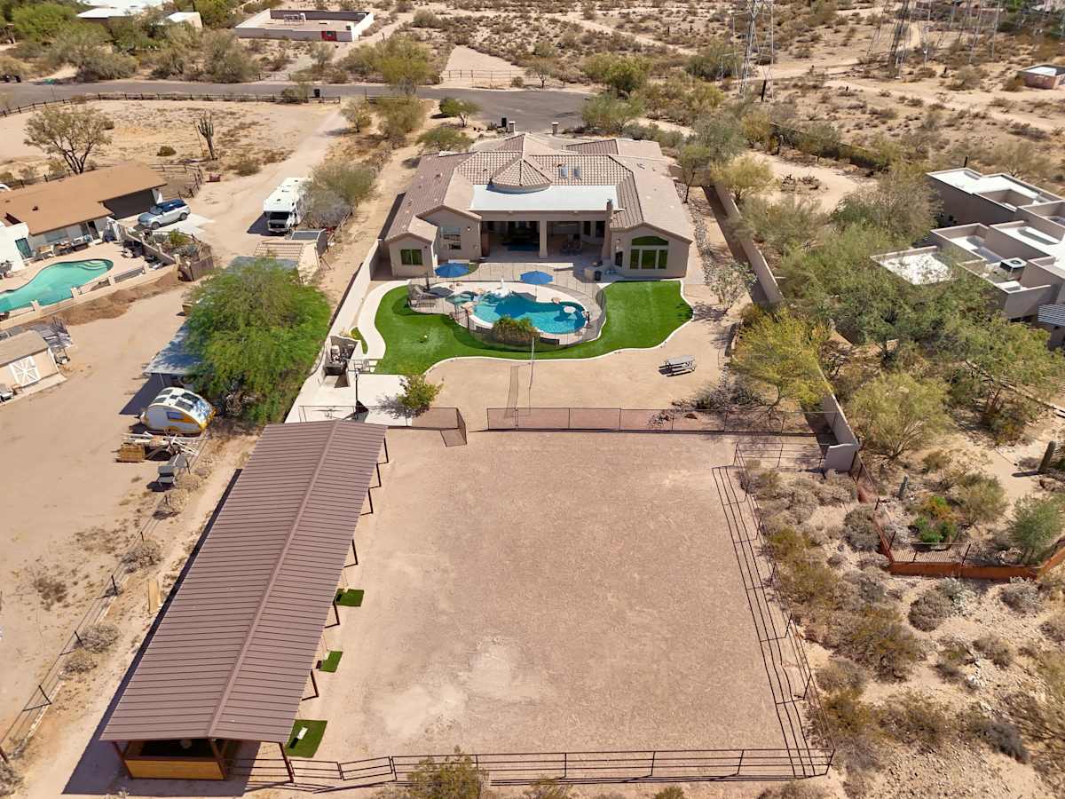 Private backyard with a sparkling pool and hot tub, BBQ grill, plus fun amenities including tetherball, volleyball, basketball, a horse stable with swings, mini golf, and darts.