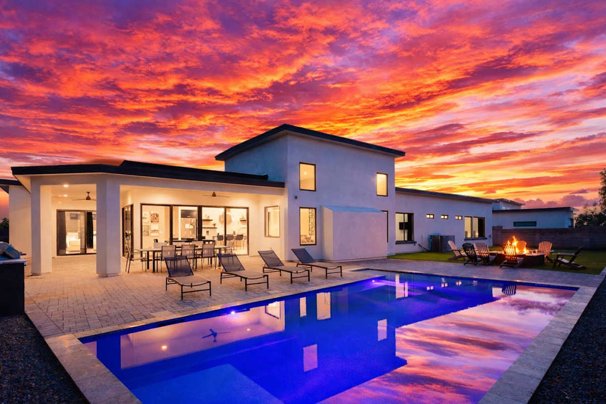 Unit 1: Stunning private yard with sparkling pool, sun loungers, lawn space, covered patio with lounge area, covered outdoor dining area, fire pit, and built-in BBQ grill!