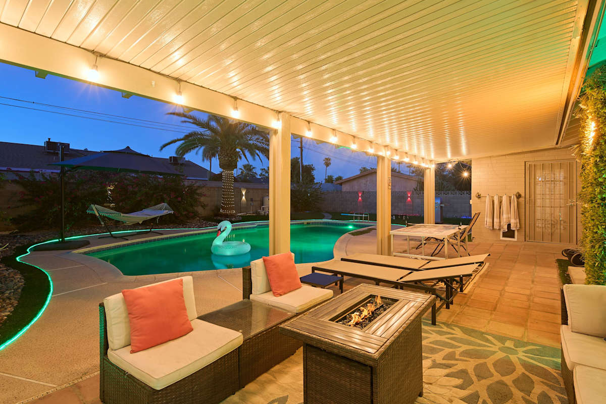 Take the plunge off the diving board into the sparkling pool, then dry off under the covered patio's fire pit lounge or challenge someone to ping pong, with a hammock and lush grass rounding out this