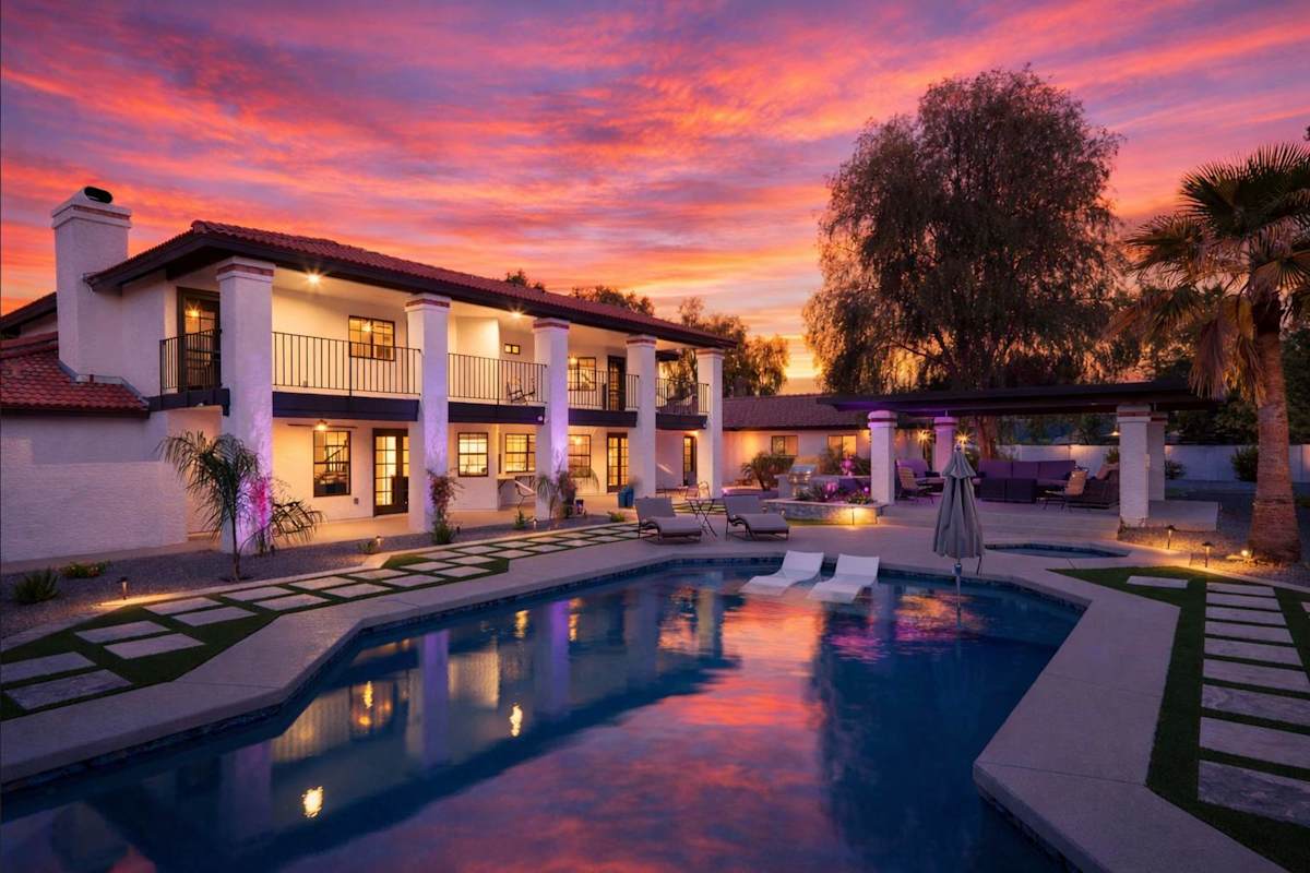 Resort-style backyard with sparkling heated pool & spa, sun loungers, BBQ grill, covered gazebo with multiple lounge areas, outdoor seating, and putting green setup.