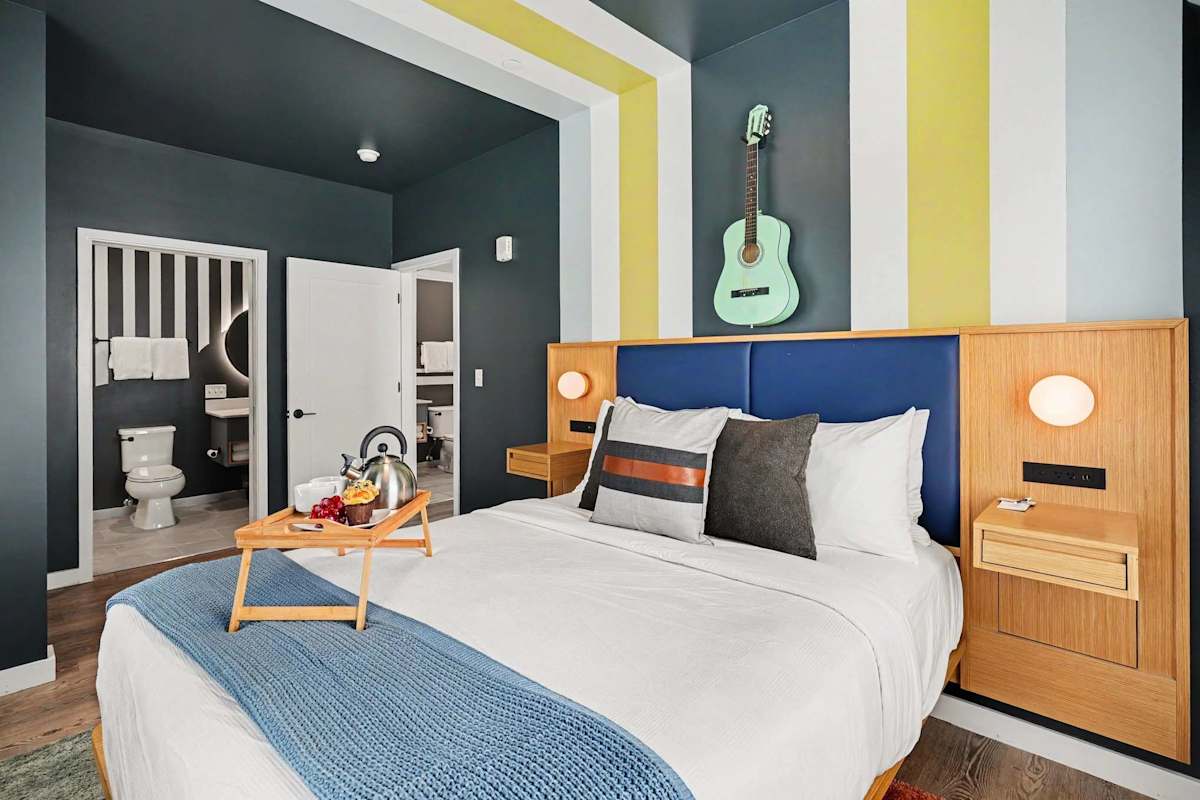 Primary Bedroom featuring a Queen bed, smart TV, closet space, and an en-suite bathroom.