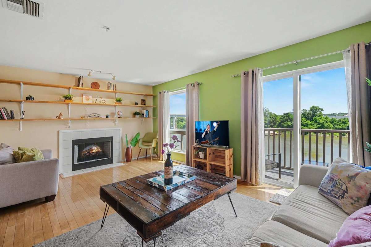 Inviting living room with a cozy fireplace, comfortable seating, Nashville-inspired décor, and a private balcony with peaceful views.