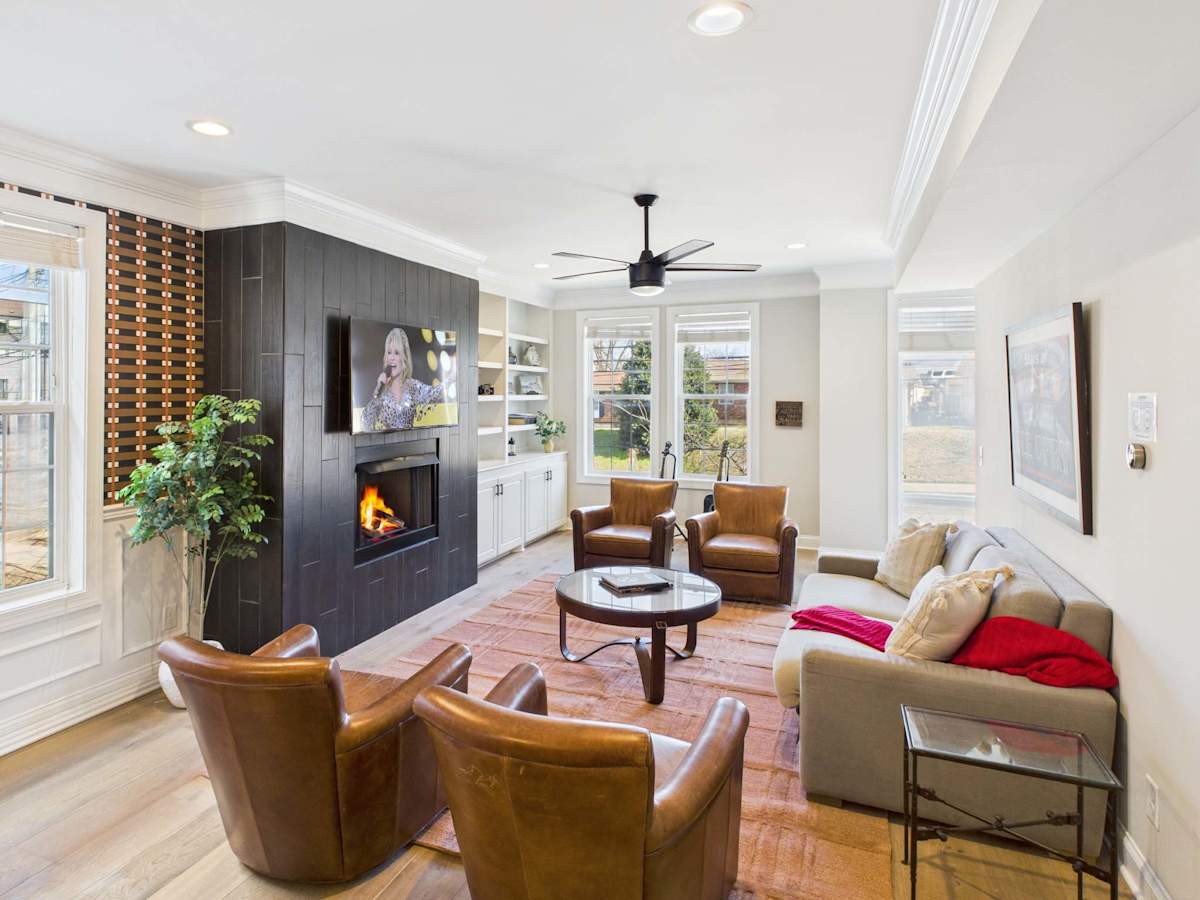 2nd Floor: Bright open-concept living area with comfortable seating, fireplace, and smart TV.