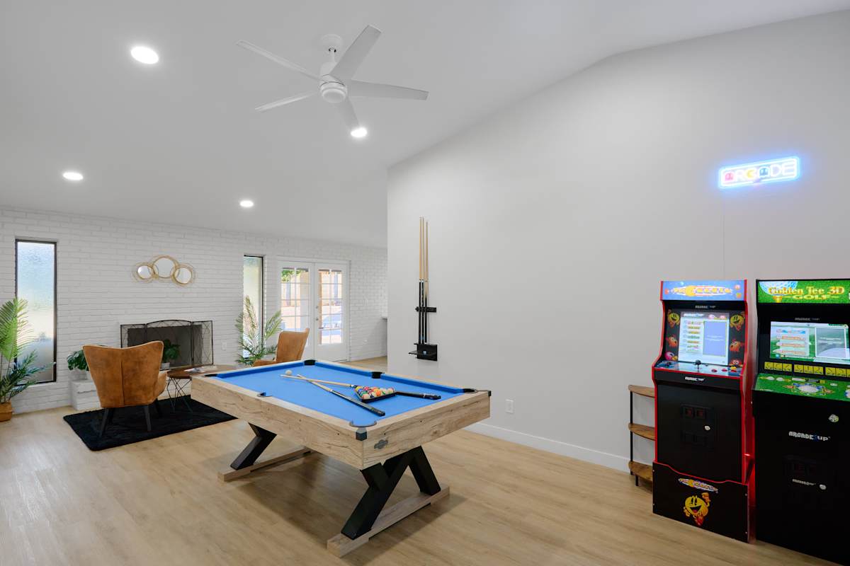 Game room delivers full-on entertainment with a pool table and retro arcade games, plus a cozy nook to lunge and unwind as evening settles in.